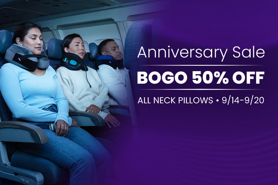 Three passengers resting on an airplane seat wearing gray and black travel neck pillows, with a purple promotional overlay reading 'Anniversary Sale BOGO 50% OFF ALL NECK PILLOWS 9/14-9/20'.