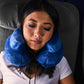 Asian woman in airplane seat wearing a blue Air Evolution neck pillow 